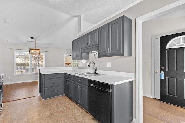 kitchen with a peninsula, a sink, light countertops, gray cabinets, and dishwasher