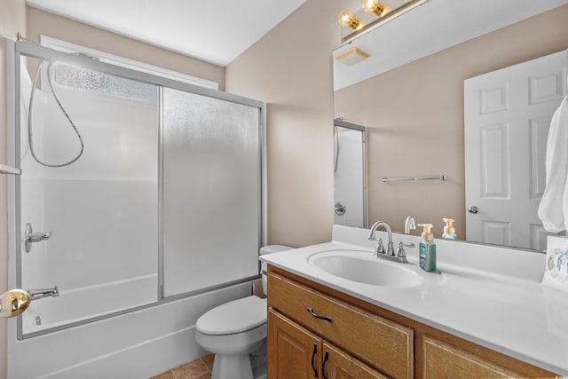 full bathroom with bath / shower combo with glass door, visible vents, toilet, vanity, and tile patterned flooring