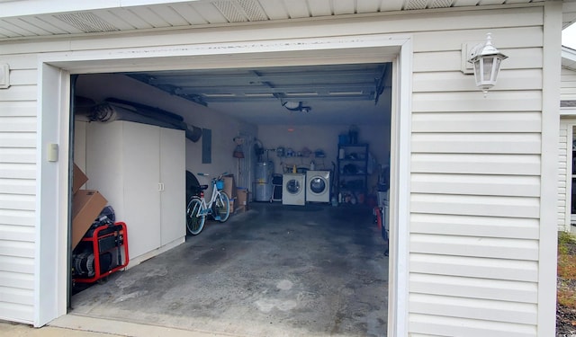 garage with water heater and washer and dryer