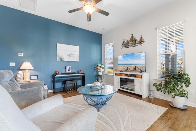 living room featuring hardwood / wood-style floors, ceiling fan, and plenty of natural light