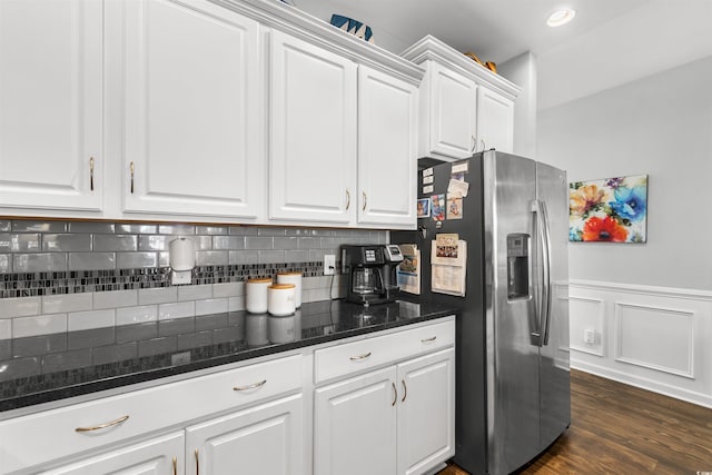 kitchen featuring dark hardwood / wood-style flooring, white cabinets, stainless steel refrigerator with ice dispenser, decorative backsplash, and dark stone countertops