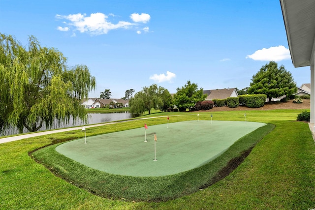 view of community featuring a lawn and a water view