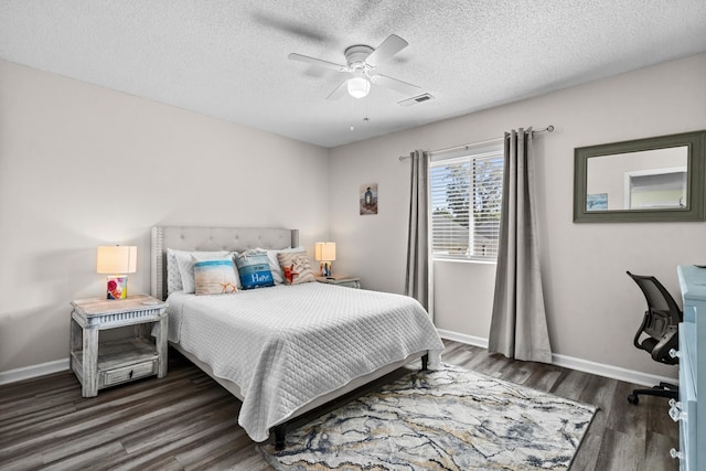 bedroom with ceiling fan, a textured ceiling, and dark hardwood / wood-style flooring