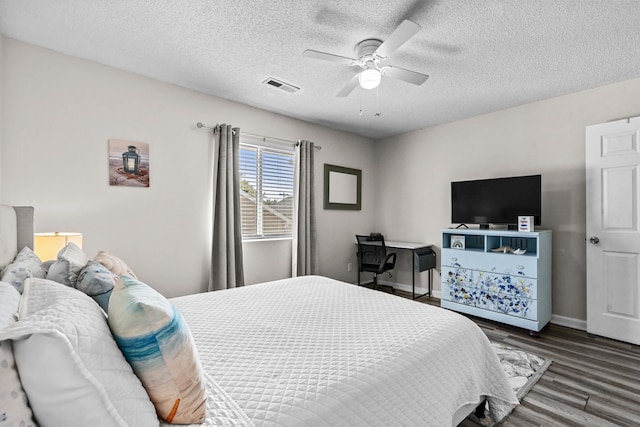 bedroom featuring a textured ceiling, ceiling fan, and dark hardwood / wood-style floors