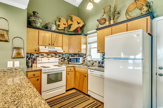 kitchen with sink, light stone counters, backsplash, white appliances, and crown molding