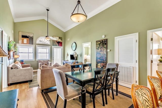 dining room featuring high vaulted ceiling, light hardwood / wood-style floors, and ceiling fan