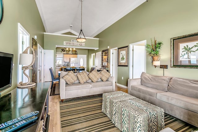 living room with high vaulted ceiling and light hardwood / wood-style floors