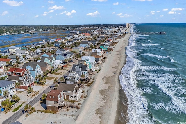 birds eye view of property with a water view and a view of the beach