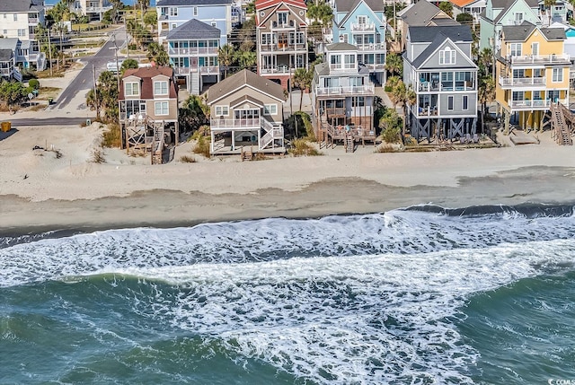 drone / aerial view featuring a view of the beach and a water view