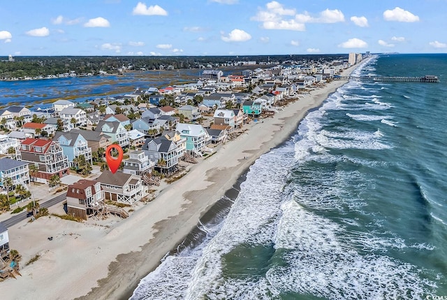 birds eye view of property featuring a water view and a beach view