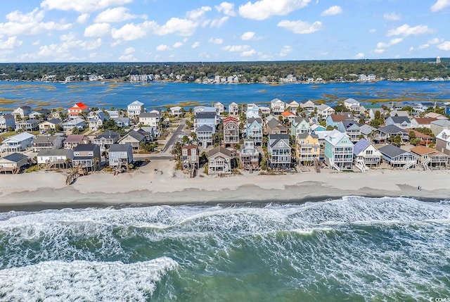 drone / aerial view featuring a water view and a beach view