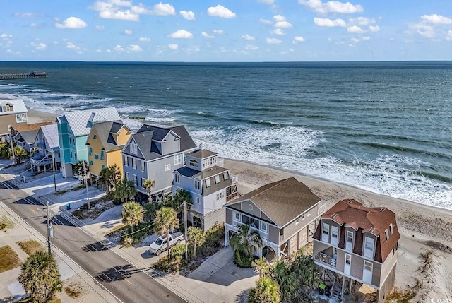 aerial view with a water view and a beach view