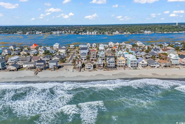 bird's eye view featuring a view of the beach and a water view