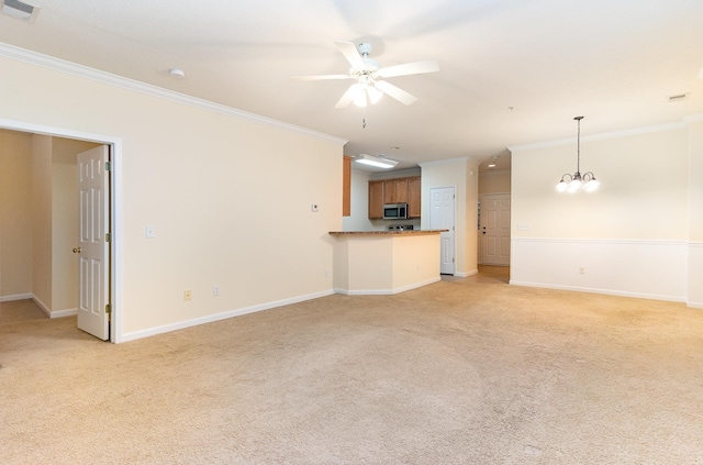 unfurnished living room with light colored carpet, ceiling fan with notable chandelier, and ornamental molding