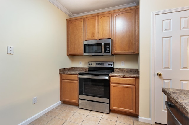 kitchen featuring ornamental molding, stainless steel appliances, and light tile patterned floors