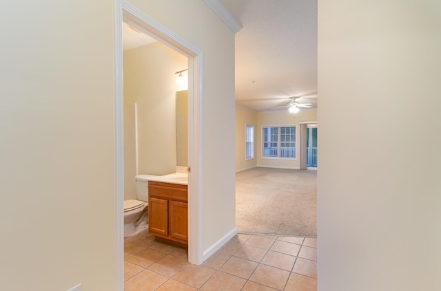 hallway with light colored carpet