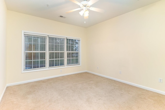 spare room featuring ceiling fan and light colored carpet