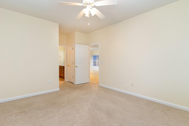 unfurnished room featuring ceiling fan and light colored carpet