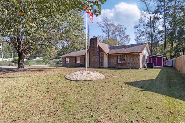 back of property featuring central AC, a storage unit, and a yard