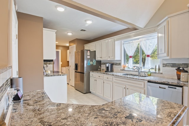 kitchen featuring tasteful backsplash, independent washer and dryer, stainless steel appliances, and sink