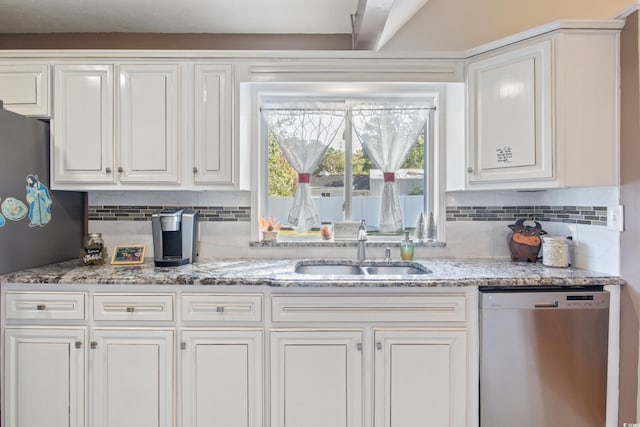 kitchen with stainless steel appliances, tasteful backsplash, sink, and white cabinets