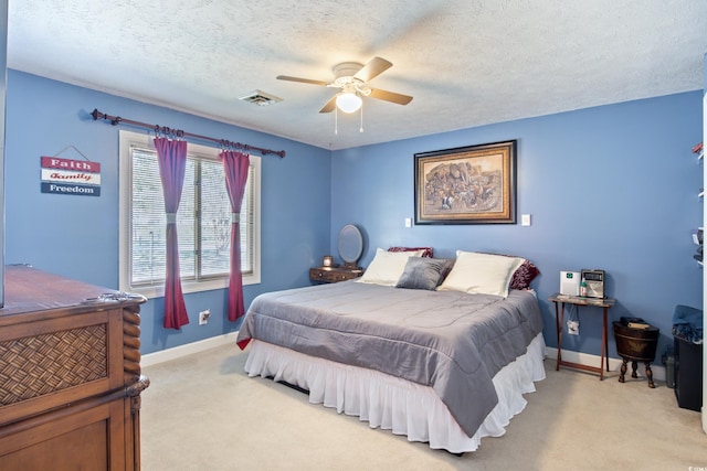 carpeted bedroom with a textured ceiling and ceiling fan