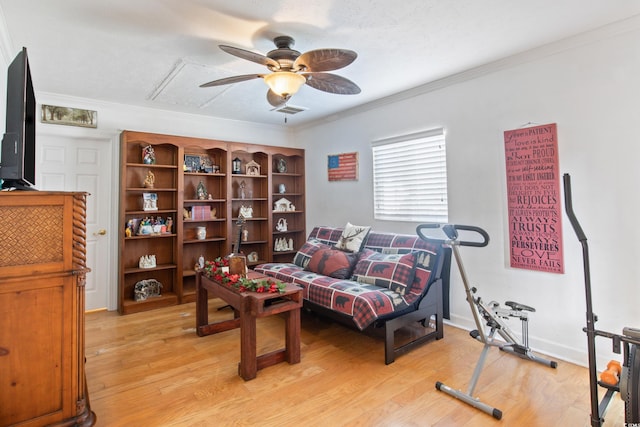 interior space with crown molding, a textured ceiling, ceiling fan, and light wood-type flooring