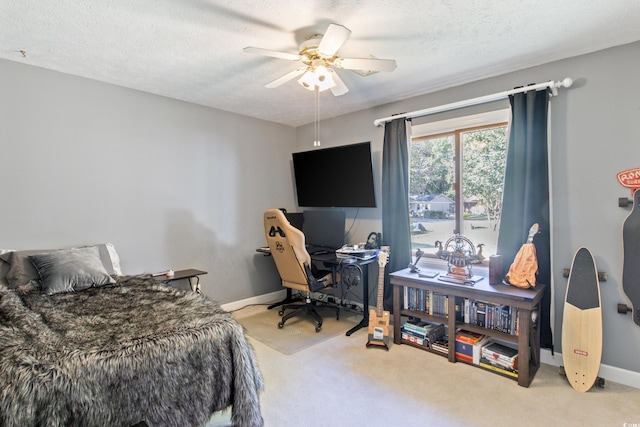 carpeted bedroom with ceiling fan and a textured ceiling