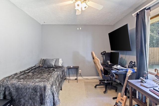 carpeted bedroom with a textured ceiling and ceiling fan