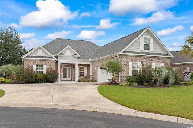 view of front of home featuring driveway, roof with shingles, an attached garage, a front lawn, and brick siding