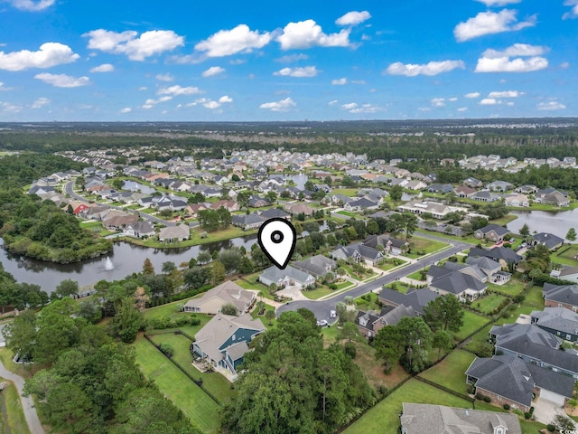 drone / aerial view featuring a residential view and a water view