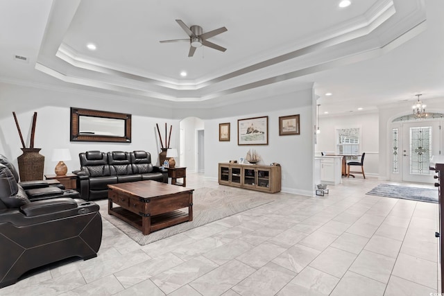 116 Ocean Sands Ct, Myrtle Beach, SC 29579 - living room featuring ceiling fan with notable chandelier, a tray ceiling, arched walkways, ornamental molding, and visible vents