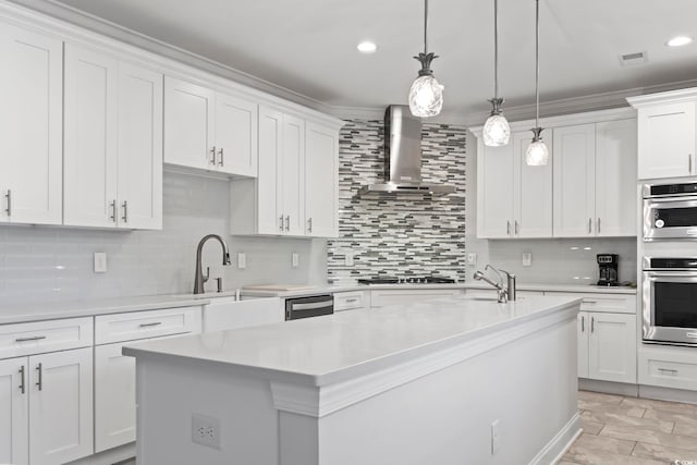 kitchen featuring visible vents, black stovetop, light countertops, and wall chimney range hood