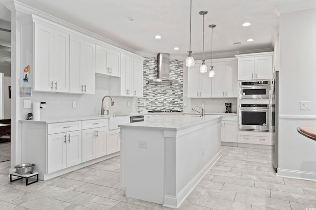 116 Ocean Sands Ct, Myrtle Beach, SC 29579 - kitchen with wall chimney exhaust hood, light countertops, a kitchen island with sink, white cabinetry, and double oven