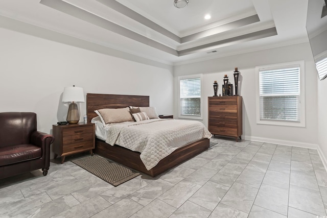 bedroom featuring visible vents, a raised ceiling, baseboards, and ornamental molding