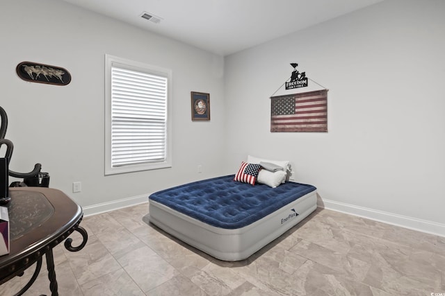 bedroom with baseboards and visible vents