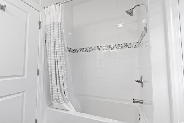 bathroom featuring shower / bath combo with shower curtain