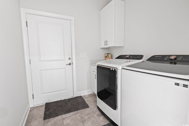 laundry room with baseboards, cabinet space, light tile patterned flooring, and washing machine and clothes dryer