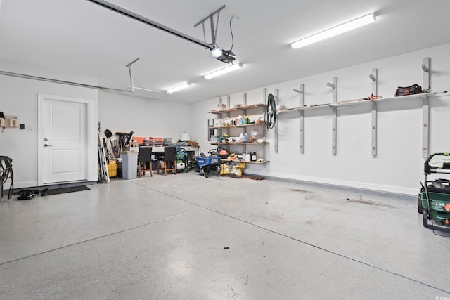 garage with a garage door opener and baseboards