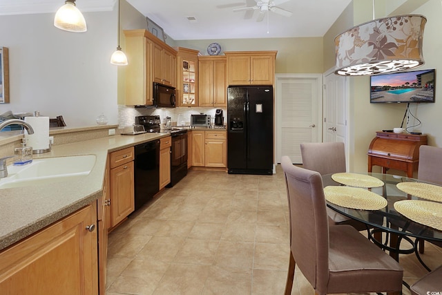 kitchen with backsplash, ceiling fan, sink, black appliances, and decorative light fixtures