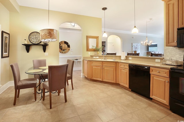 kitchen featuring light stone countertops, sink, black appliances, a notable chandelier, and hanging light fixtures