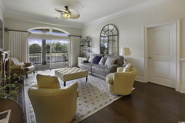 living room with dark hardwood / wood-style floors, ceiling fan, and ornamental molding