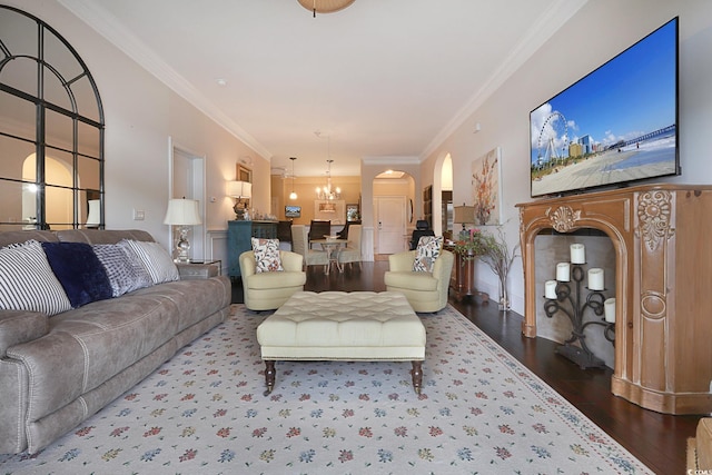 living room featuring hardwood / wood-style floors, a notable chandelier, and ornamental molding