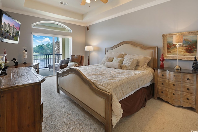 bedroom featuring light carpet, a raised ceiling, ceiling fan, access to exterior, and ornamental molding