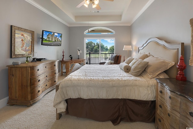 carpeted bedroom featuring access to outside, a tray ceiling, ceiling fan, and crown molding