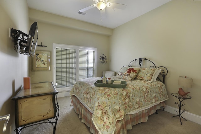 bedroom featuring ceiling fan and light carpet