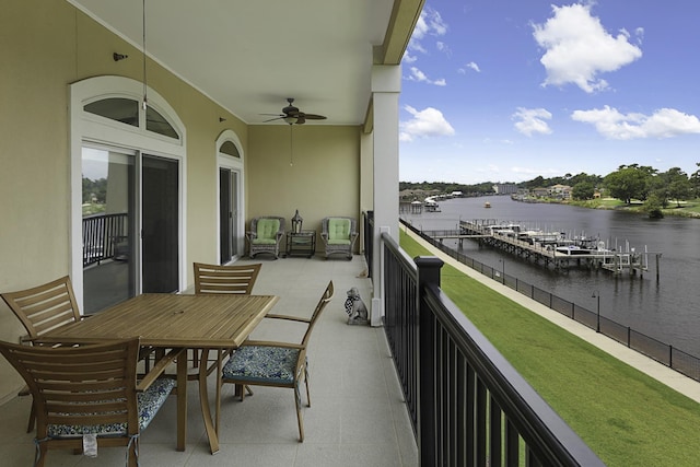 balcony featuring a water view and ceiling fan