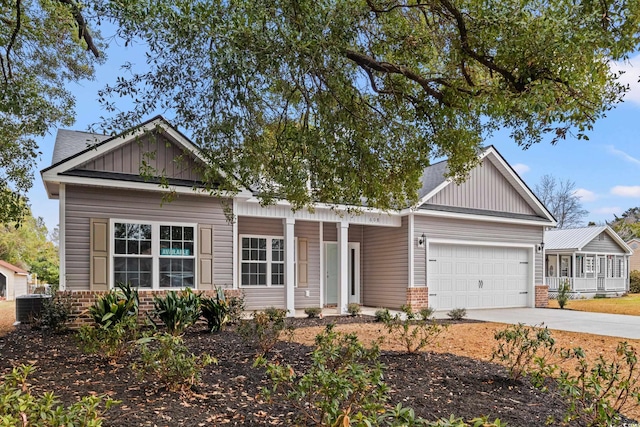 view of front of home with board and batten siding, brick siding, driveway, and a garage