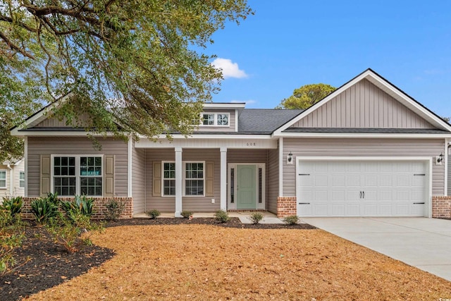 view of front of property with brick siding, concrete driveway, a garage, and roof with shingles