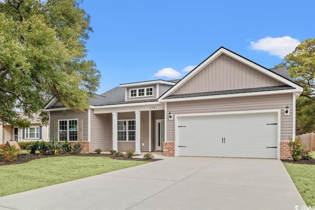 608 Britt St, Georgetown, SC 29440 - view of front of house featuring brick siding, driveway, and a front yard